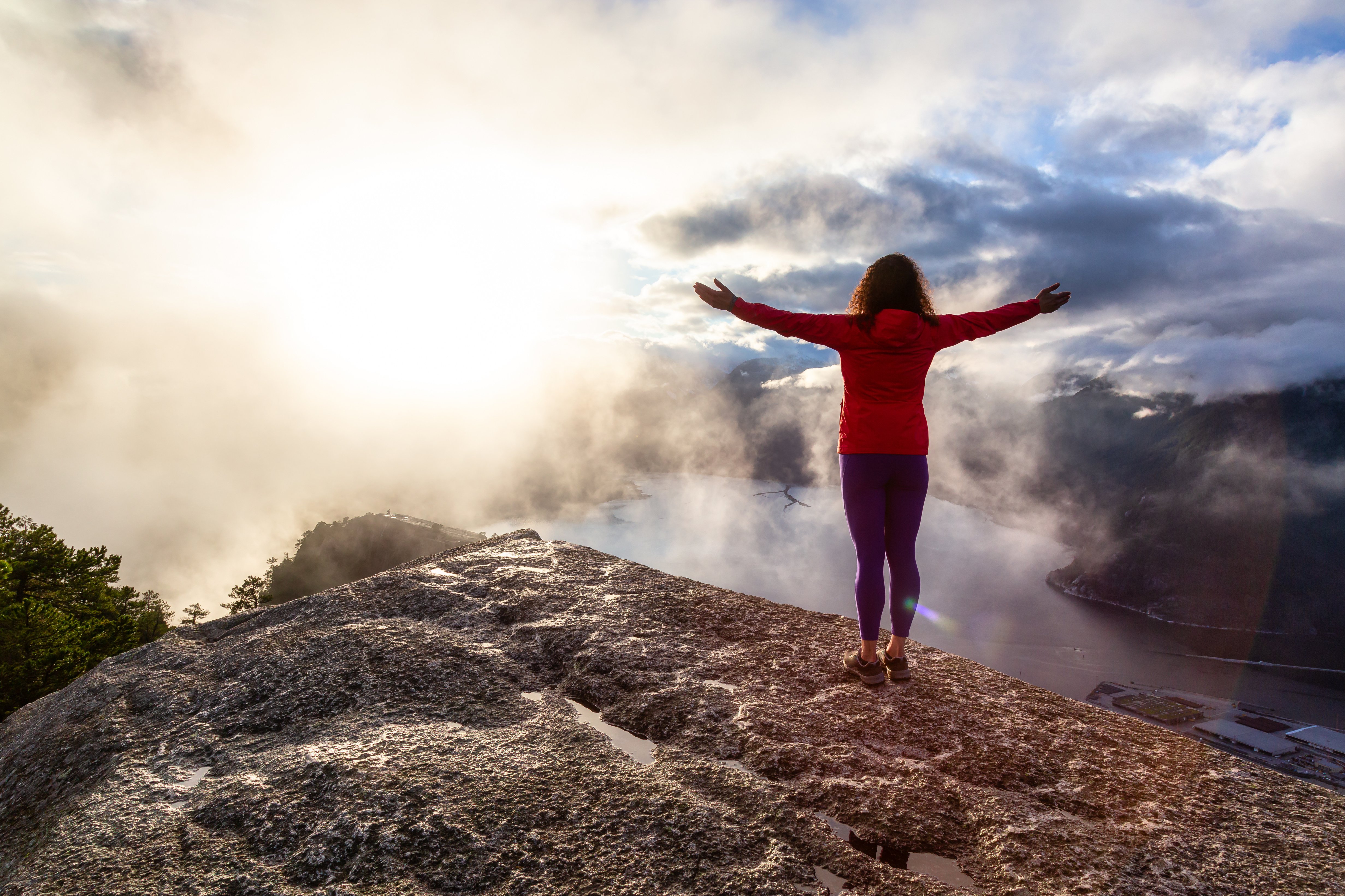 Woman Standing on Mountain Peak